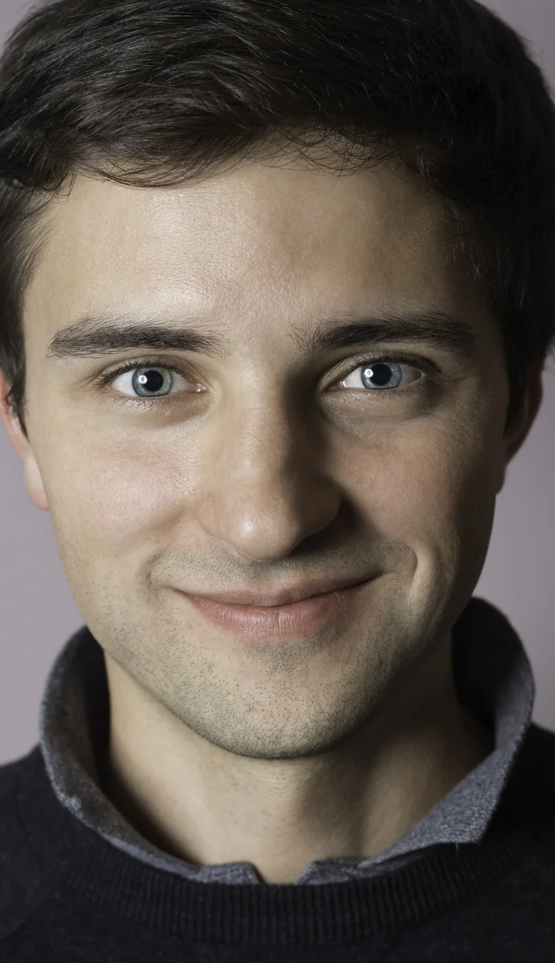 Corporate headshot, close crop on a light background