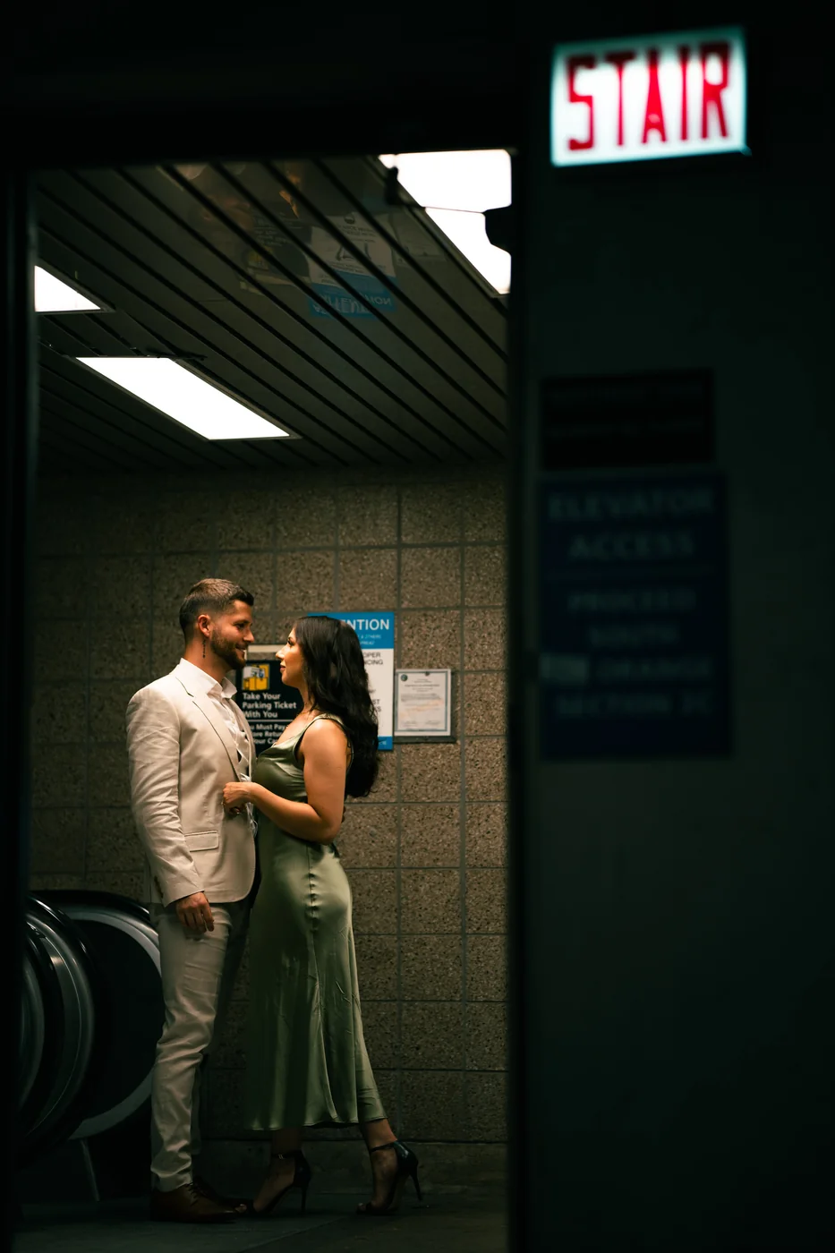 Karolina and Daniel under a stair sign downtown