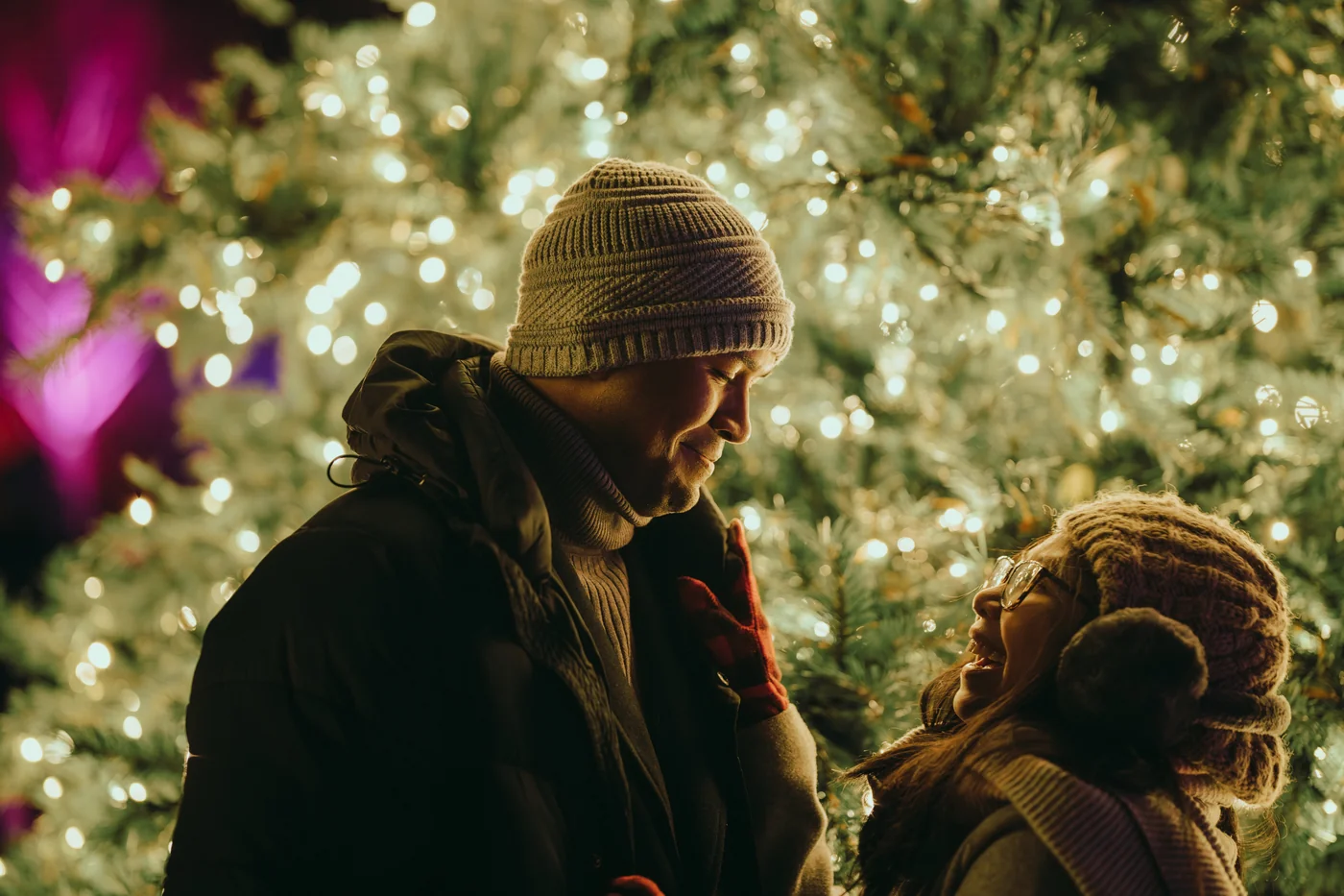 Rochelle and Joshua in front of a lit winter tree
