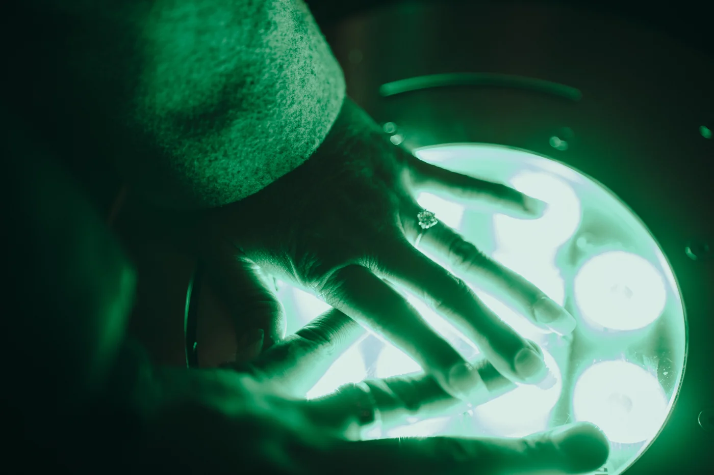 Their hands and the ring over a glowing installation