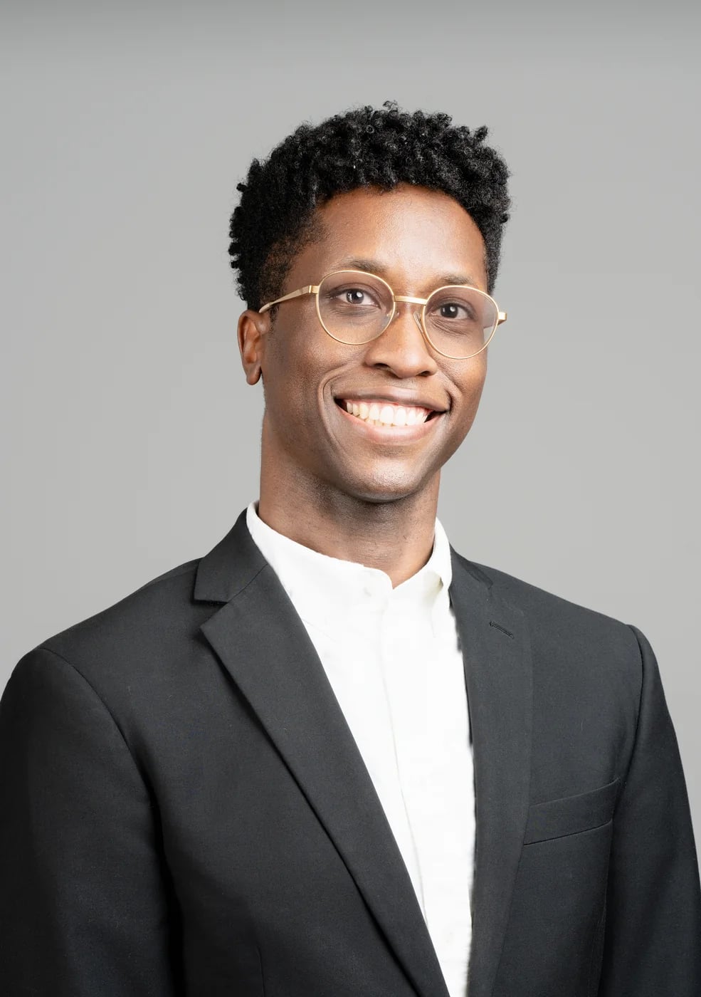 Corporate headshot on a grey background
