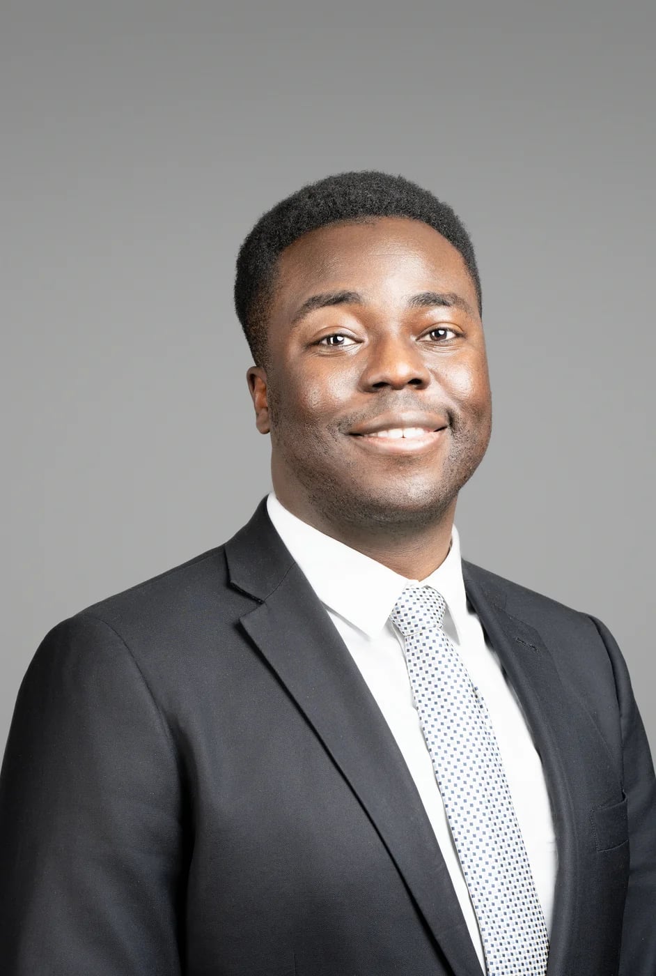 Corporate headshot on a grey background