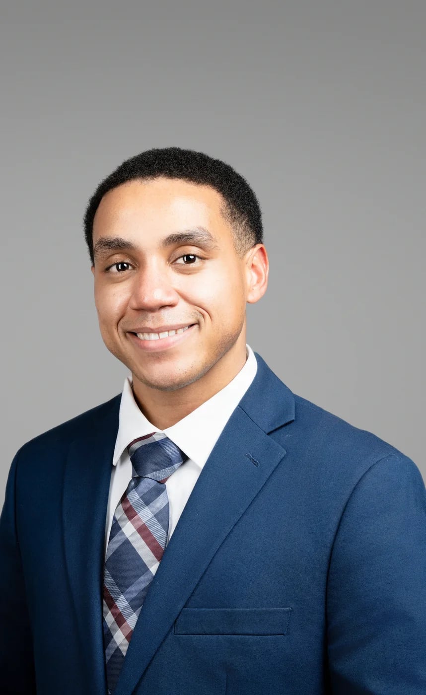 Corporate headshot on a grey background