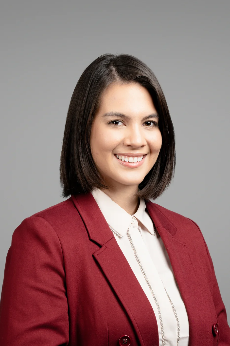 Corporate headshot on a grey background