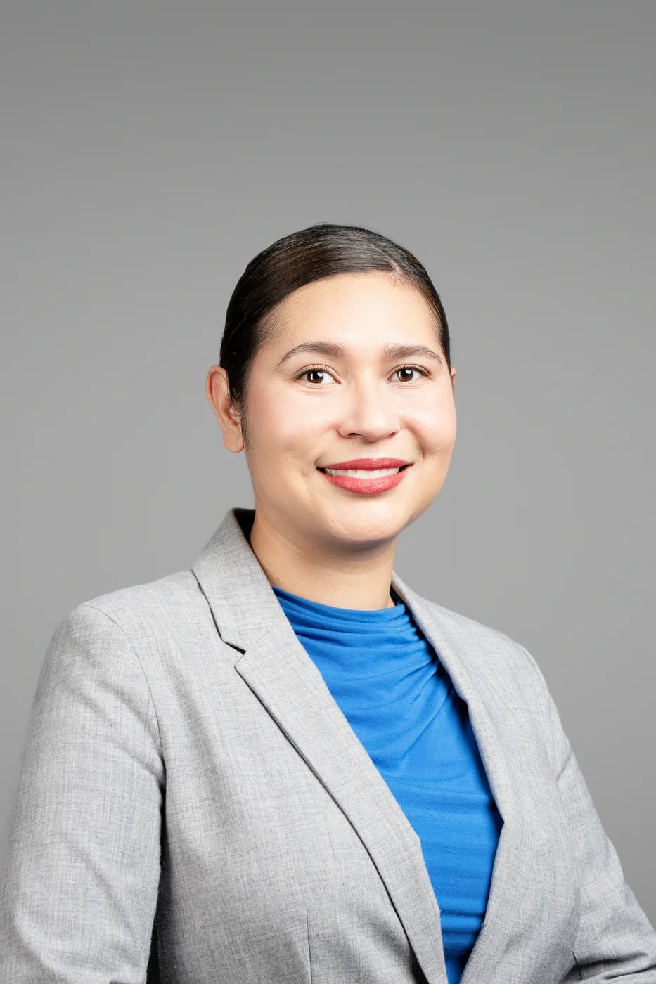 Corporate headshot on a grey background