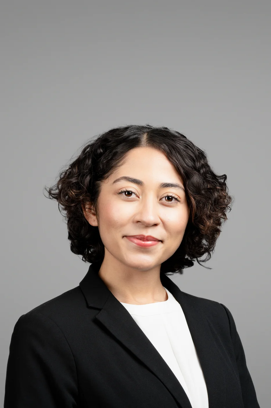 Corporate headshot on a grey background