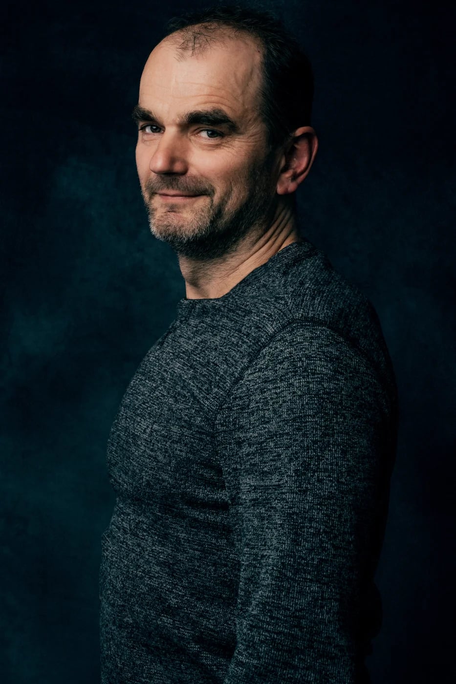 Studio portrait on a dark backdrop